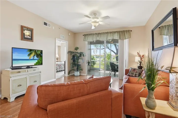 Living area with a ceiling fan and wood finished floors