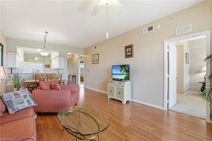 Living area featuring ceiling fan and light wood finished floors