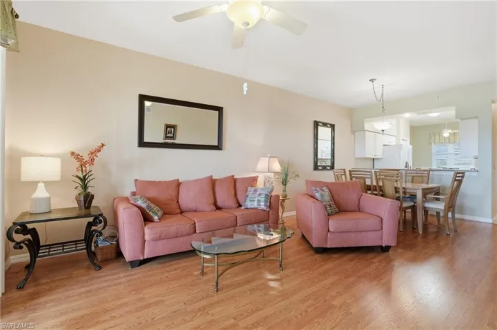 Living area with light wood-style floors and ceiling fan