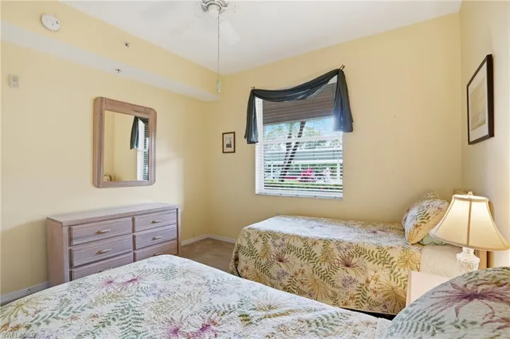 Bedroom featuring a ceiling fan and light colored carpet