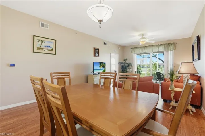 Dining room with light wood-style floors and ceiling fan