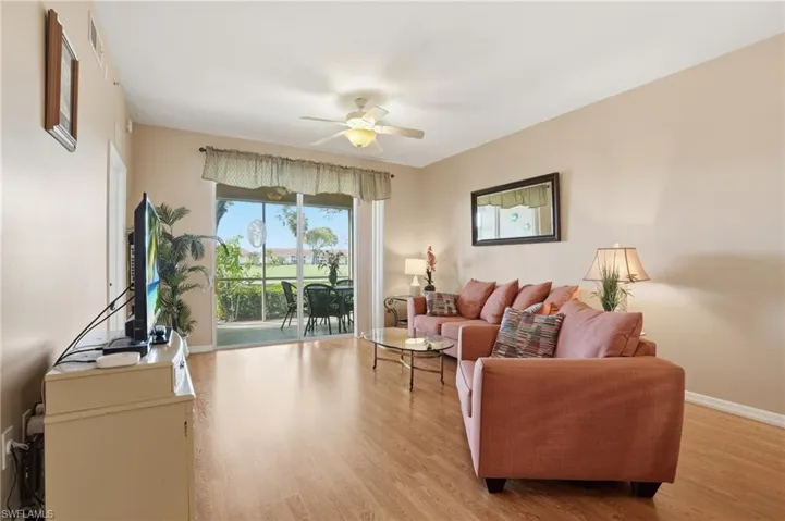 Living area featuring light wood finished floors and a ceiling fan