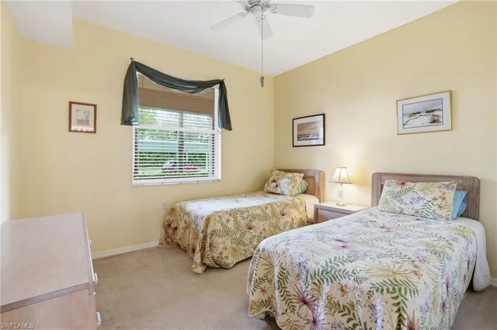 Bedroom with light carpet and ceiling fan
