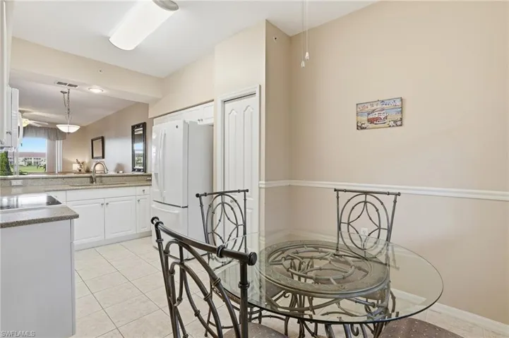 Dining room featuring light tile patterned floors and a ceiling fan