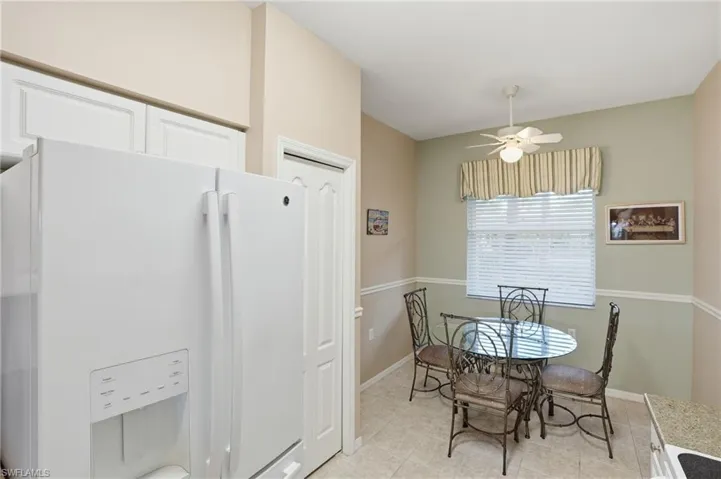 Dining area featuring ceiling fan and light tile patterned floors