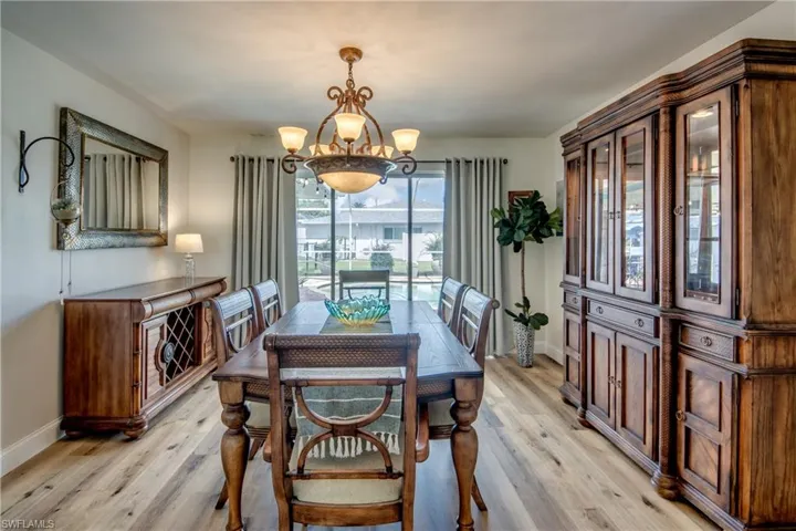 Dining space featuring light hardwood / wood-style floors and an inviting chandelier