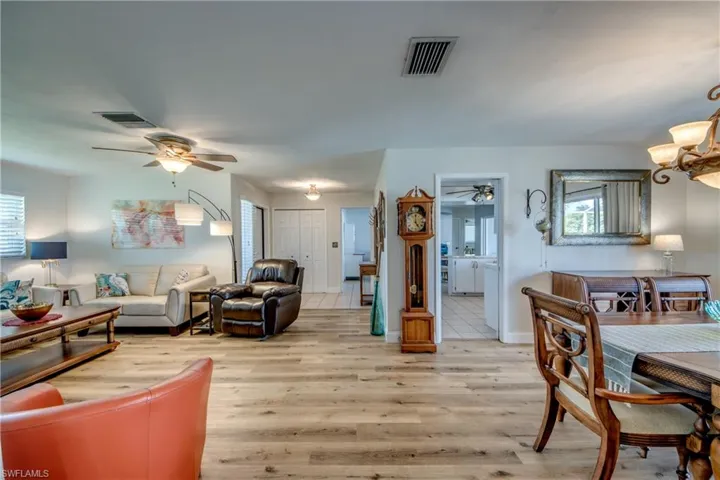 Living room featuring wood-type flooring and ceiling fan