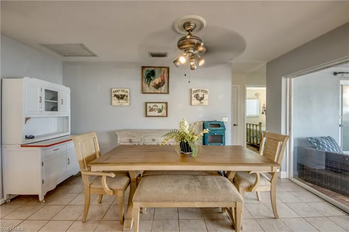 Dining space featuring light tile flooring and ceiling fan