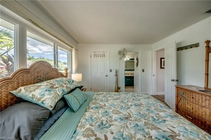 Bedroom with hardwood / wood-style floors and ensuite bathroom