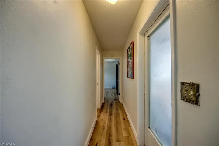 Hall with light hardwood / wood-style floors