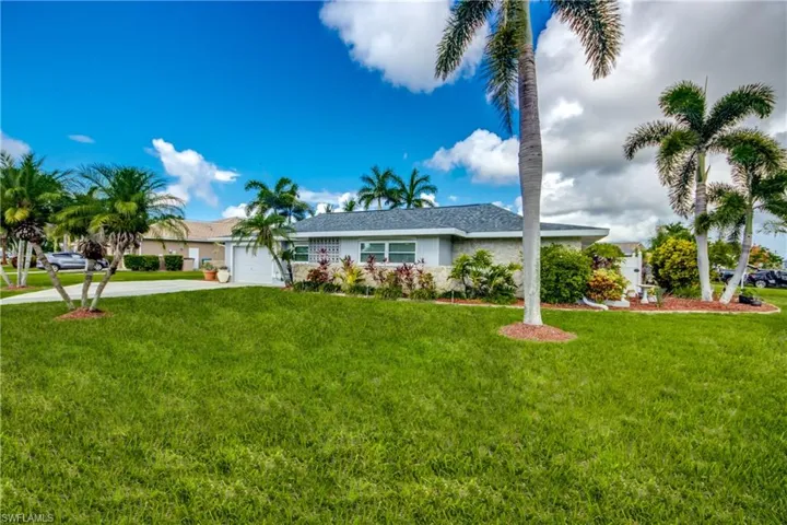 Ranch-style house with a garage and a front yard