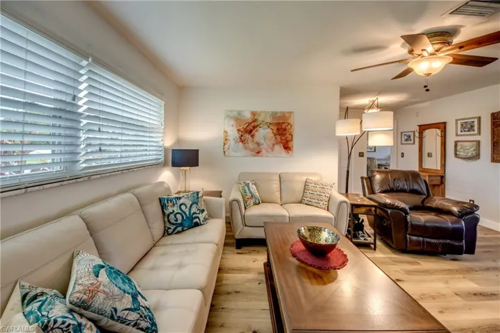 Living room with ceiling fan and light wood-type flooring