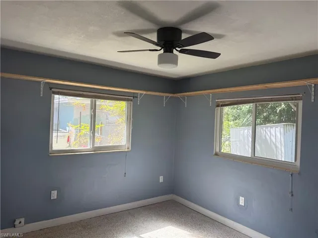 bedroom with ceiling fan, a healthy amount of sunlight, and a textured ceiling