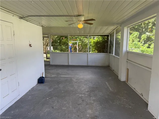 Unfurnished sunroom with wood ceiling and ceiling fan