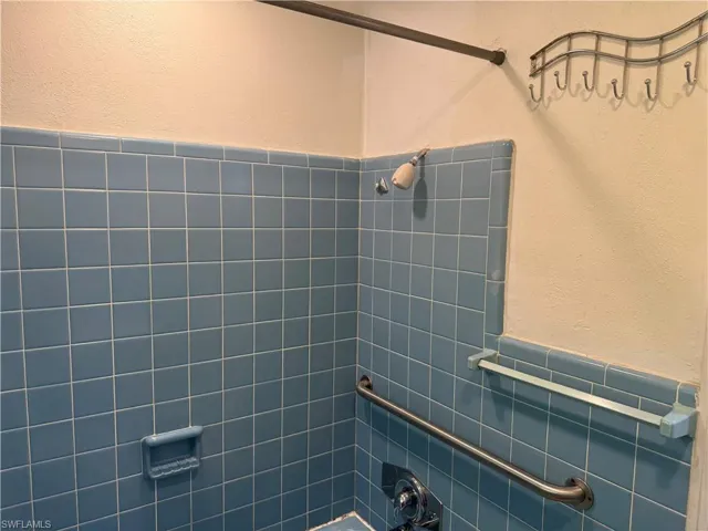 Bathroom featuring tile walls and tiled shower
