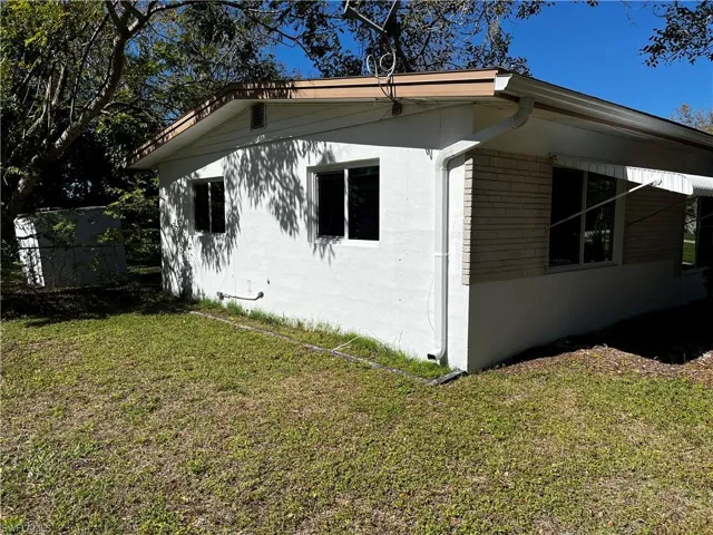 View of home's exterior with a yard