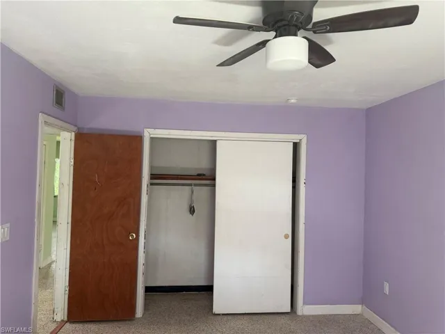Bedroom with a closet and ceiling fan