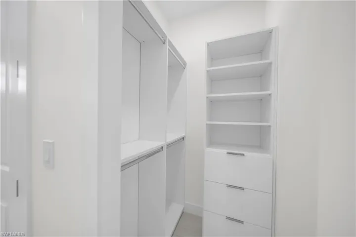 Integrated closet system with shelving, drawers, and hanging rods