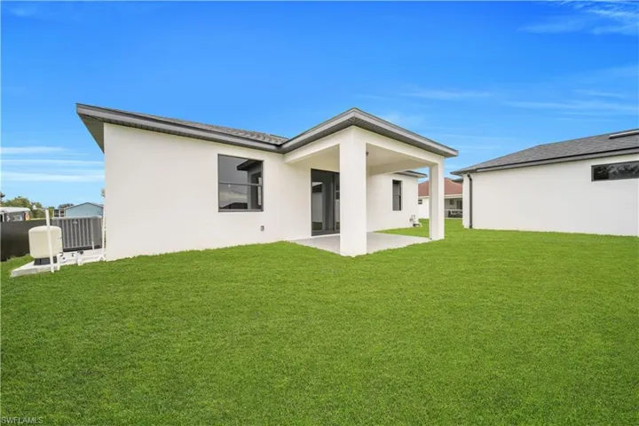 Modern single-level residence showcasing a clean architectural design with gabled rooflines, white exterior cladding, and dark-framed windows