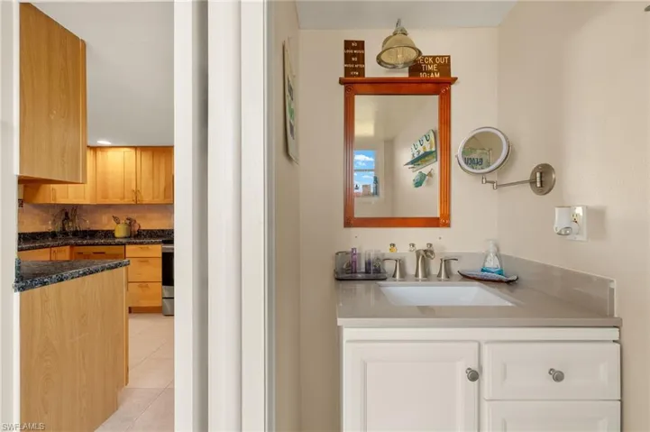 Bathroom with vanity, tile patterned floors, and decorative backsplash