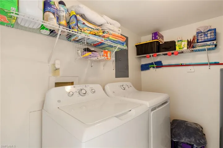 Washroom featuring washing machine and clothes dryer and electric panel