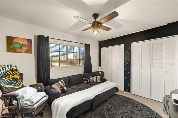 Bedroom featuring two closets, carpet floors, and ceiling fan