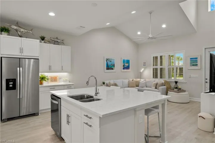 Kitchen featuring sink, light hardwood / wood-style flooring, white cabinets, and stainless steel appliances