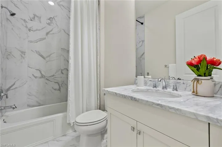 Full bathroom featuring vanity, tile patterned flooring, toilet, and shower / bath combination with curtain