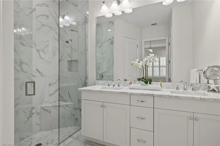 Bathroom featuring double vanity and walk in shower