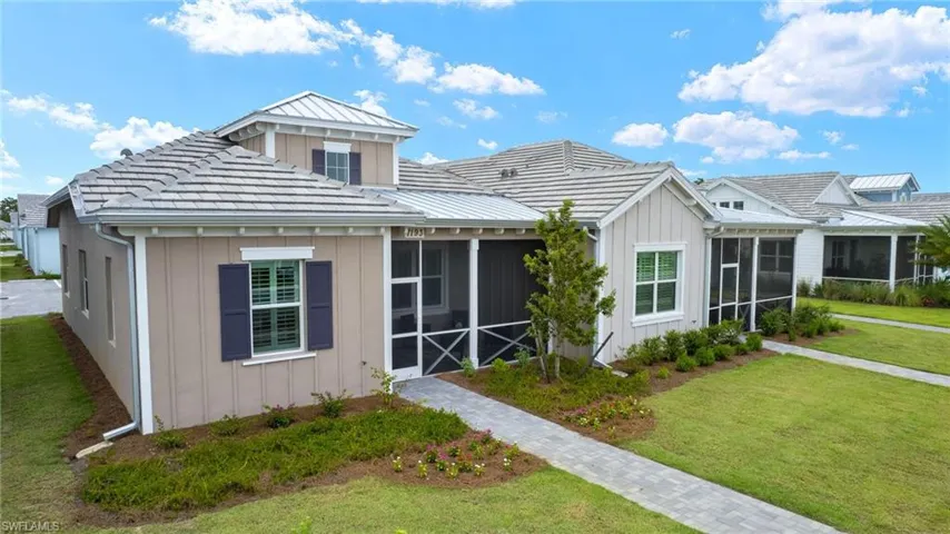 View of front of home with a sunroom and a front yard