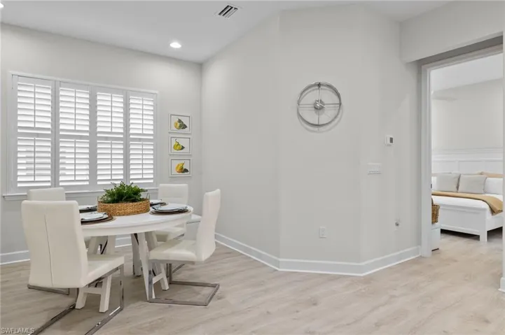 Dining space with light hardwood / wood-style flooring