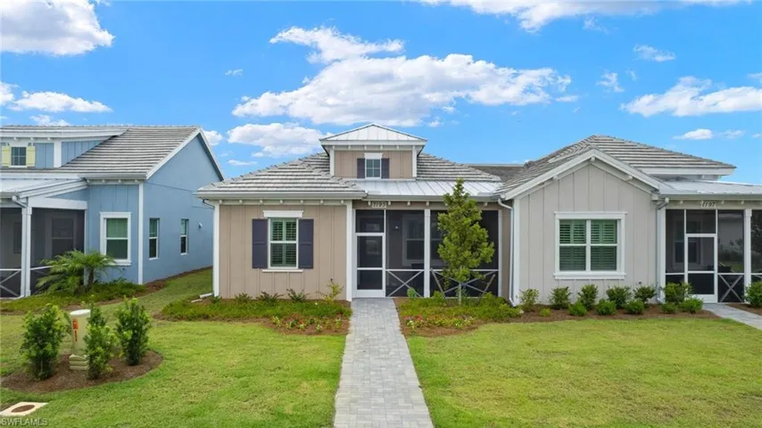View of front of house with a sunroom and a front lawn