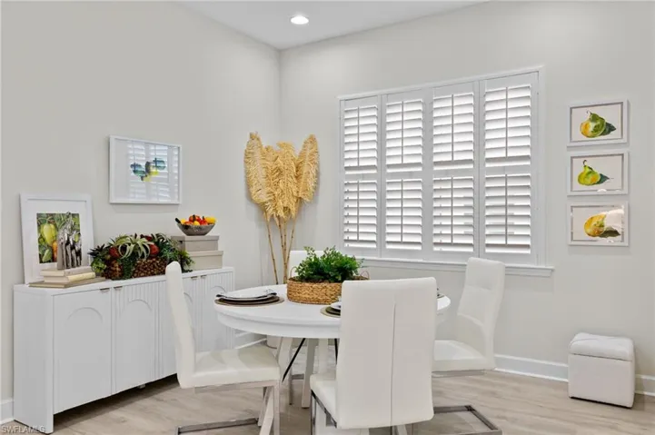Dining space with plenty of natural light and light hardwood / wood-style flooring
