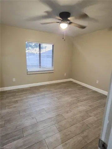Unfurnished room featuring wood finish floors and ceiling fan