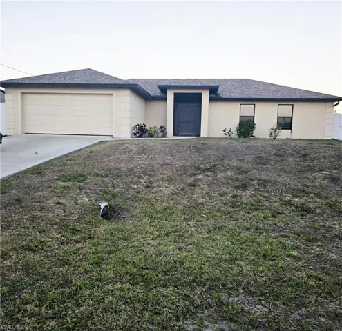 View of front of house featuring stucco siding, an attached garage, roof with shingles, and concrete driveway