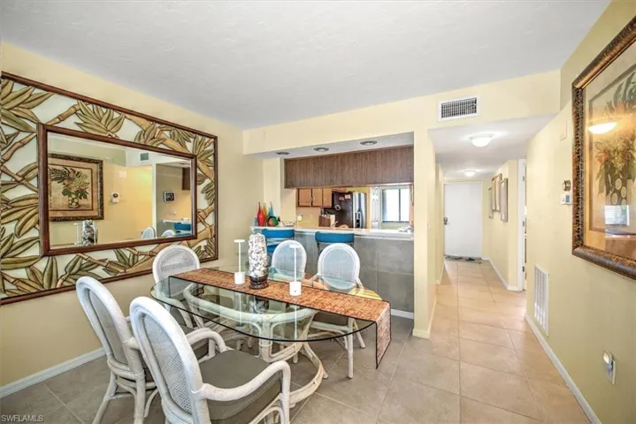 Dining space with light tile patterned flooring