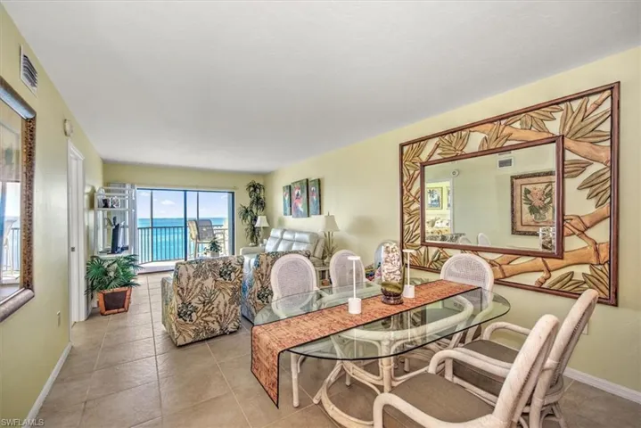 Dining area with light tile patterned flooring and a water view