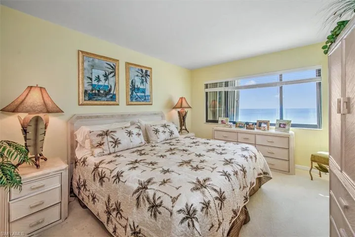 Carpeted bedroom with a water view