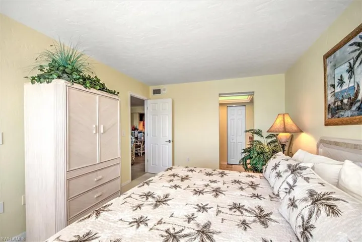 Bedroom with a textured ceiling and a closet
