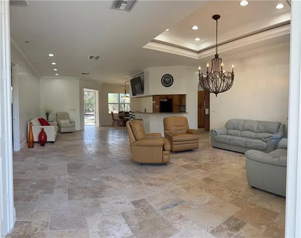 Tray ceiling, crown molding, chandelier with open, light filled space ideal for entertaining.