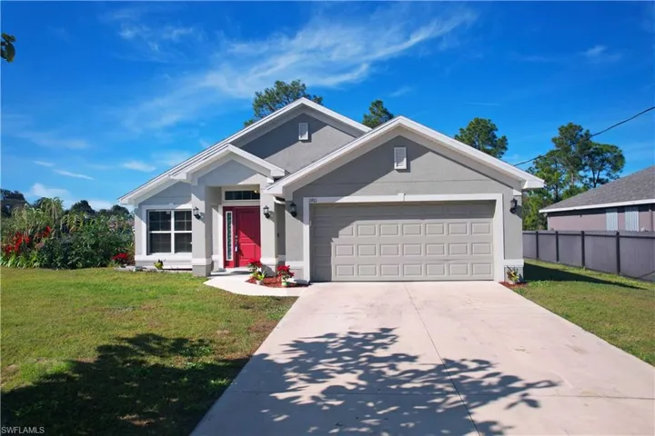 Single story home featuring stucco siding, driveway, and an attached garage