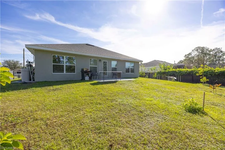 Rear view of property with stucco siding and a patio