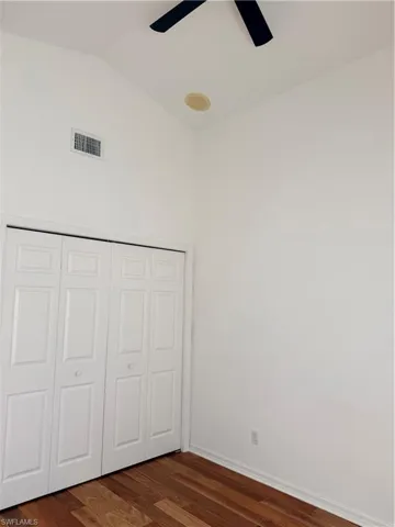 Second bedroom featuring  a closet, a ceiling fan, and vaulted ceiling
