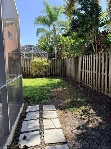 Fenced backyard with a  lanai