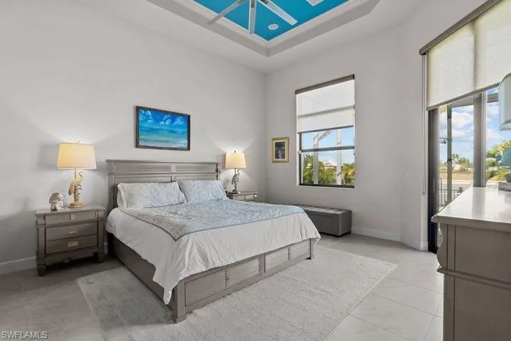 Bedroom with a raised ceiling and a high ceiling