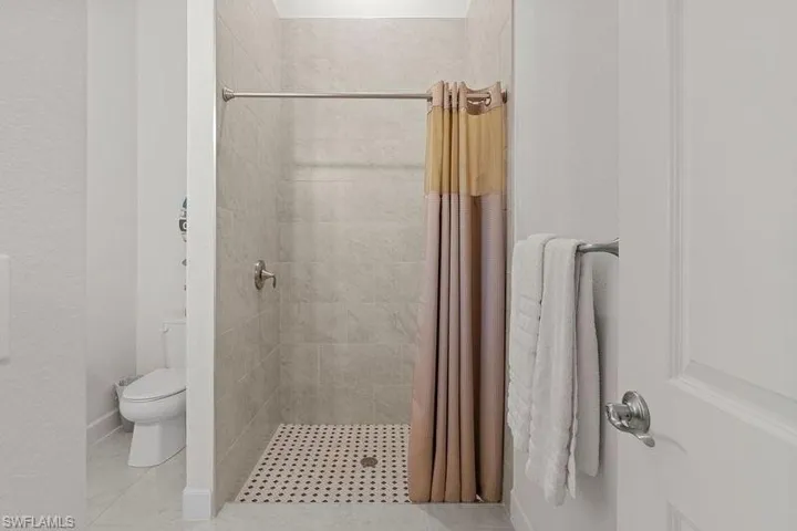 Bathroom with toilet and walk in shower
