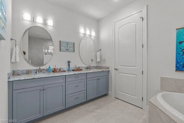 Bathroom featuring vanity and a relaxing tiled tub