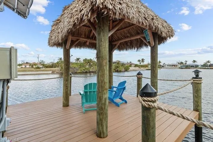 View of dock featuring a gazebo and a water view