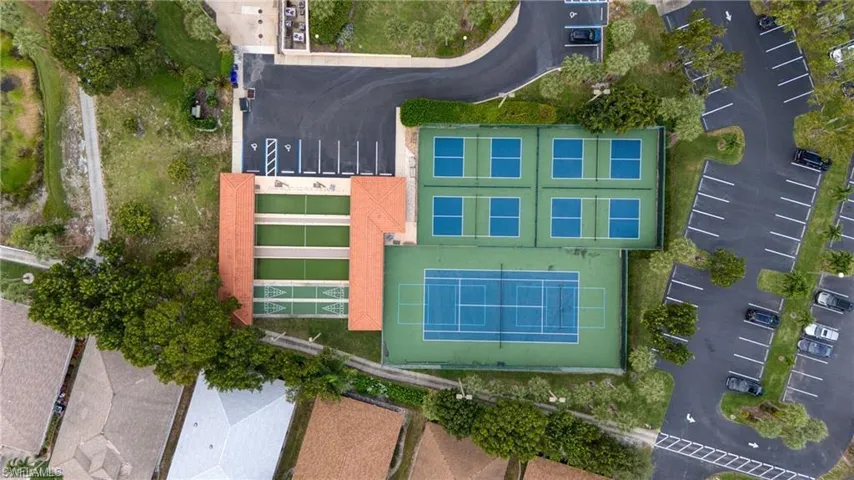 Aerial view showcasing multiple recreational courts, including four pickleball courts, a full-size tennis court, and three shuffleboard courts