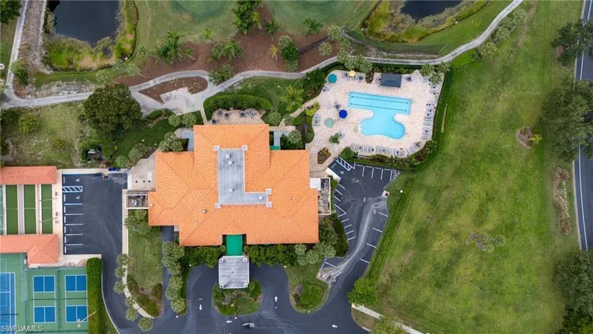 Extensive property featuring a large building with a terracotta tile roof, a multi-section swimming pool with surrounding lounge areas, multiple tennis courts, and bocce ball courts